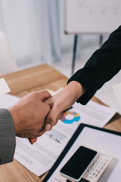 cropped-view-of-business-partners-shaking-hands-an-SUBGQMC.jpg